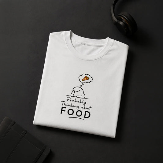 White graphic tee with cute character thinking about pizza, bold 'Probably Thinking about FOOD' text, streetwear style