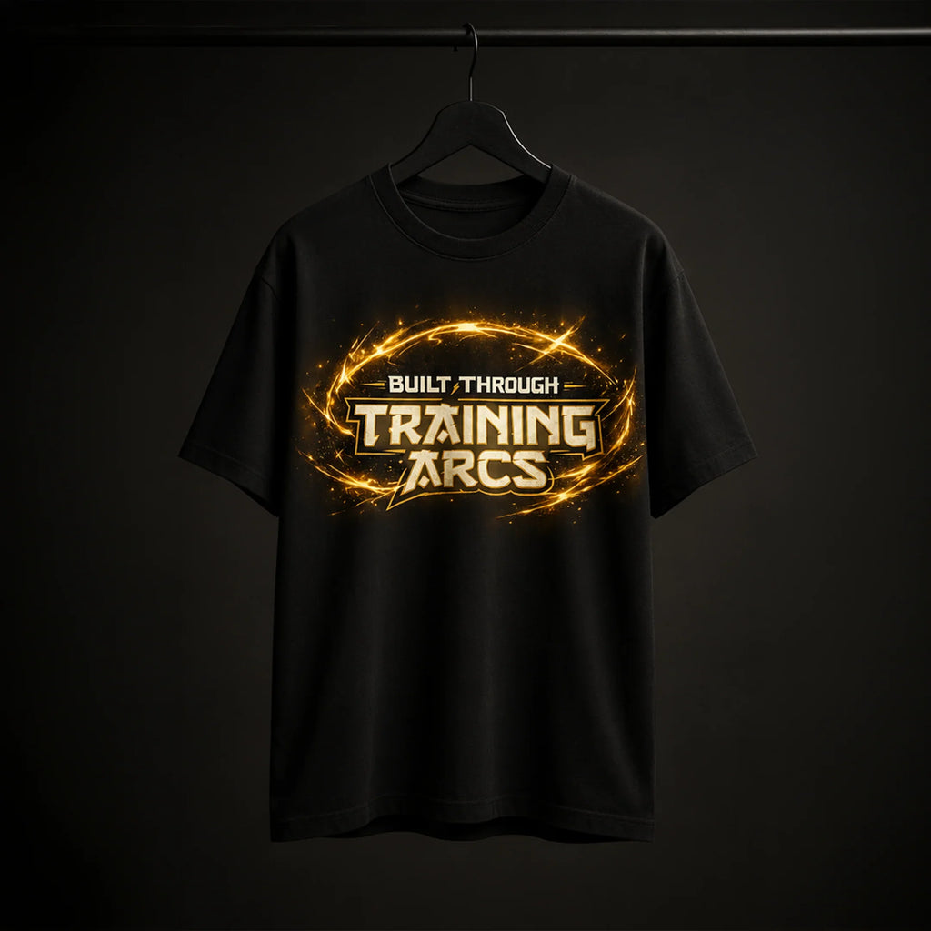 Black streetwear tee with 'Built Through Training Arcs' graphic, glowing gold design, bold gym motivation apparel