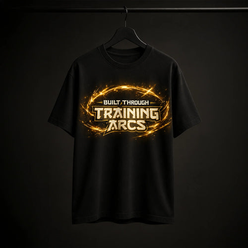 Black streetwear tee with 'Built Through Training Arcs' graphic, glowing gold design, bold gym motivation apparel