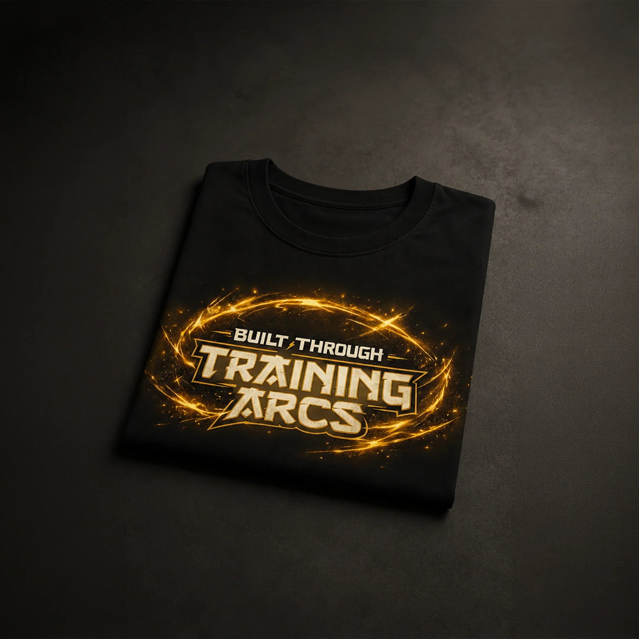 Black gym tee with 'Built Through Training Arcs' in glowing gold, bold streetwear design for fitness enthusiasts