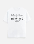 White graphic tee with 'Extremely Allergic to Mornings' text and sleepy sun design, bold streetwear style