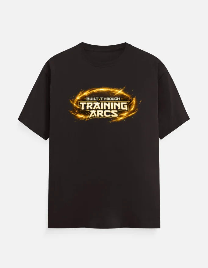Black streetwear tee with 'Built Through Training Arcs' graphic in fiery gold, bold design for gym and anime fans