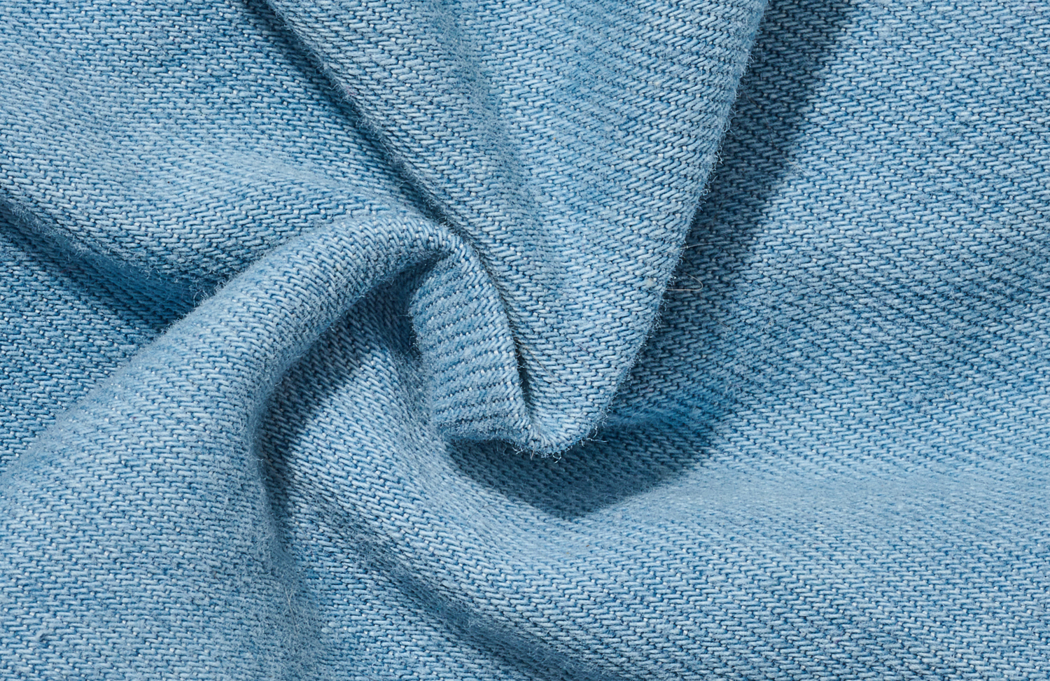 Close-up of blue denim fabric with folds