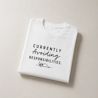 White graphic tee with 'Currently Avoiding Responsibilities' text and sleeping sloth design, bold streetwear style